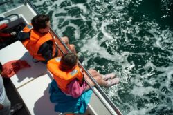 Two boys on our family Whale and Dolphin Tour in West Cork safe in their life vests and having fun
