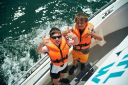Two boys on our family Whale and Dolphin Tour in West Cork safe in their life vests and having fun